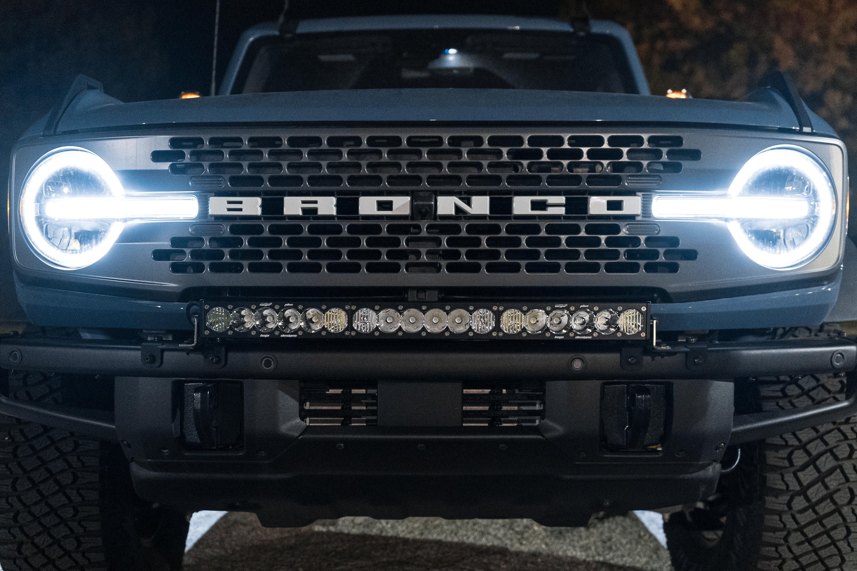 blue bronco with lights on at night