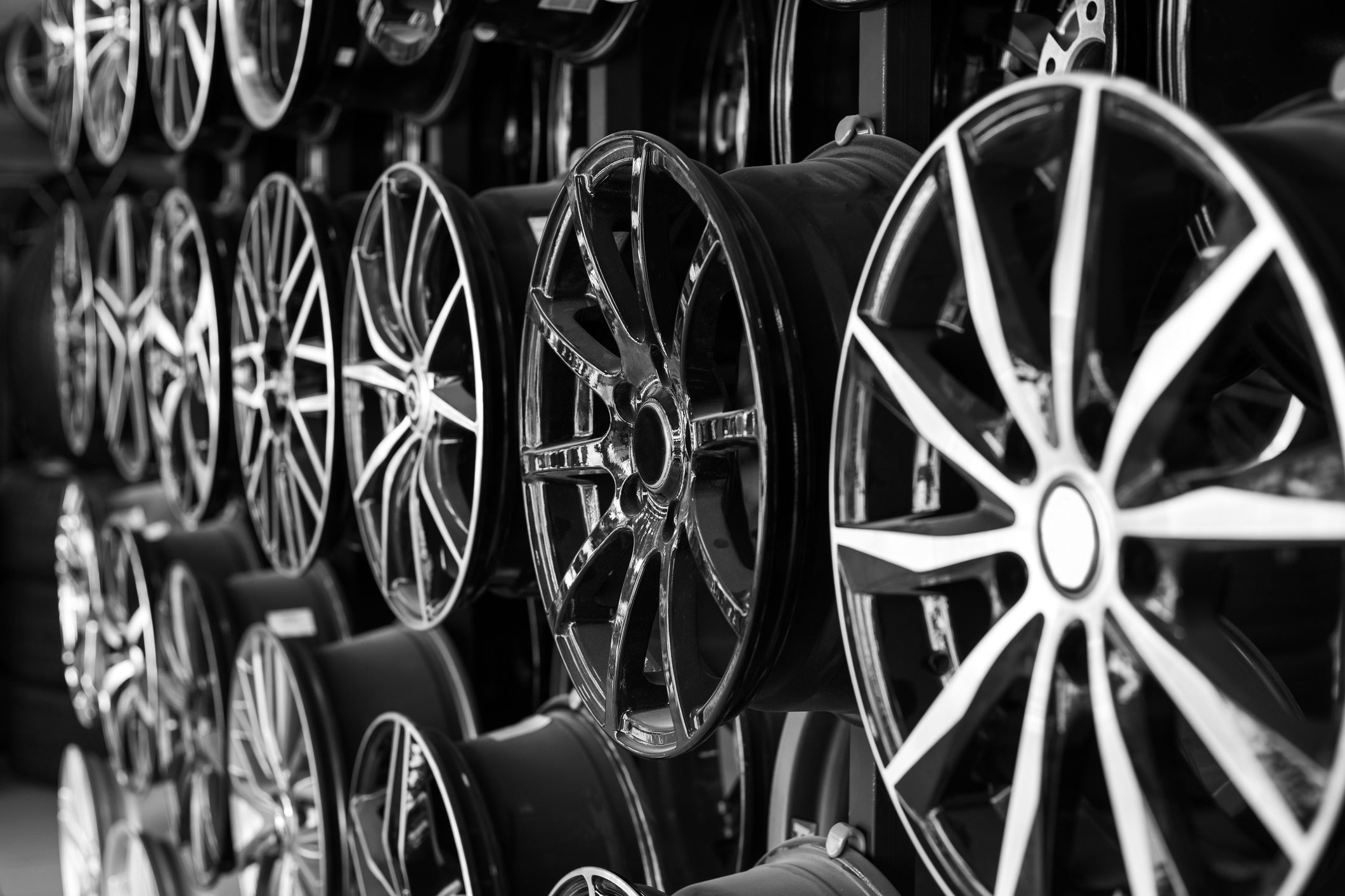 different types of car wheels lining a wall