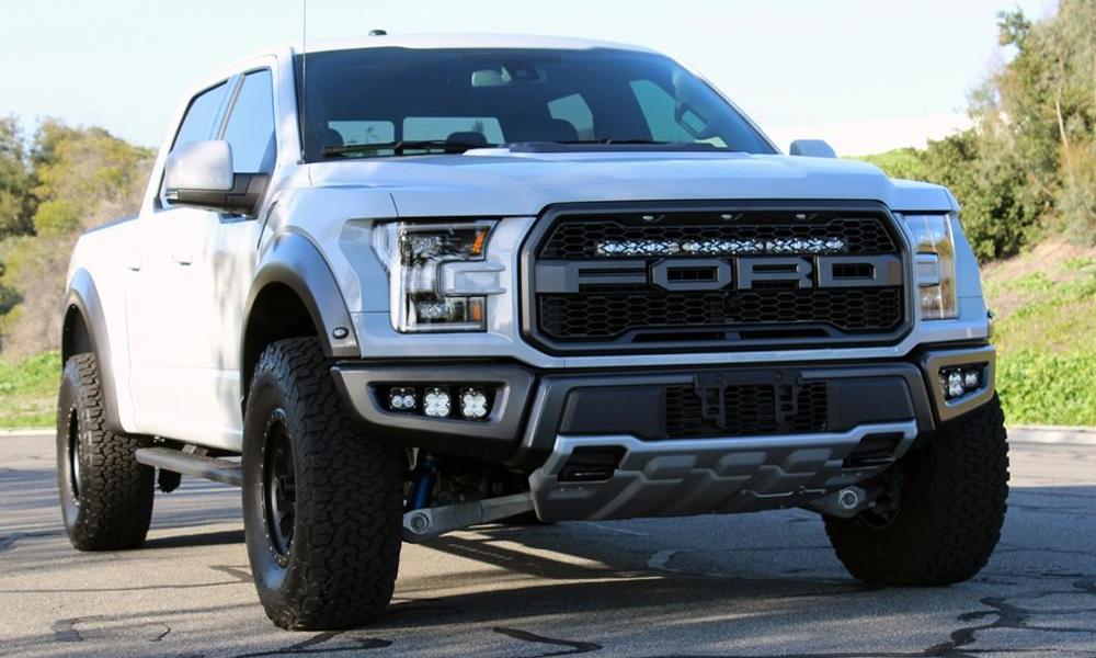 White Raptor with the Baja Designs 2017-2019 behind the grille Raptor Light bar