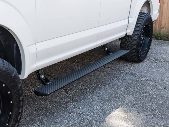AMP POWER STEPS for Ford F-Series & Raptor & Superduty shown on a white truck
