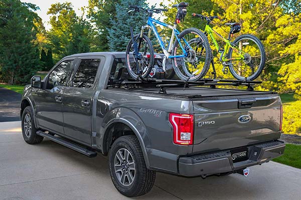 Powertrax Pro XR Bed Cover with rack accessory supporting two bikes on an F-150